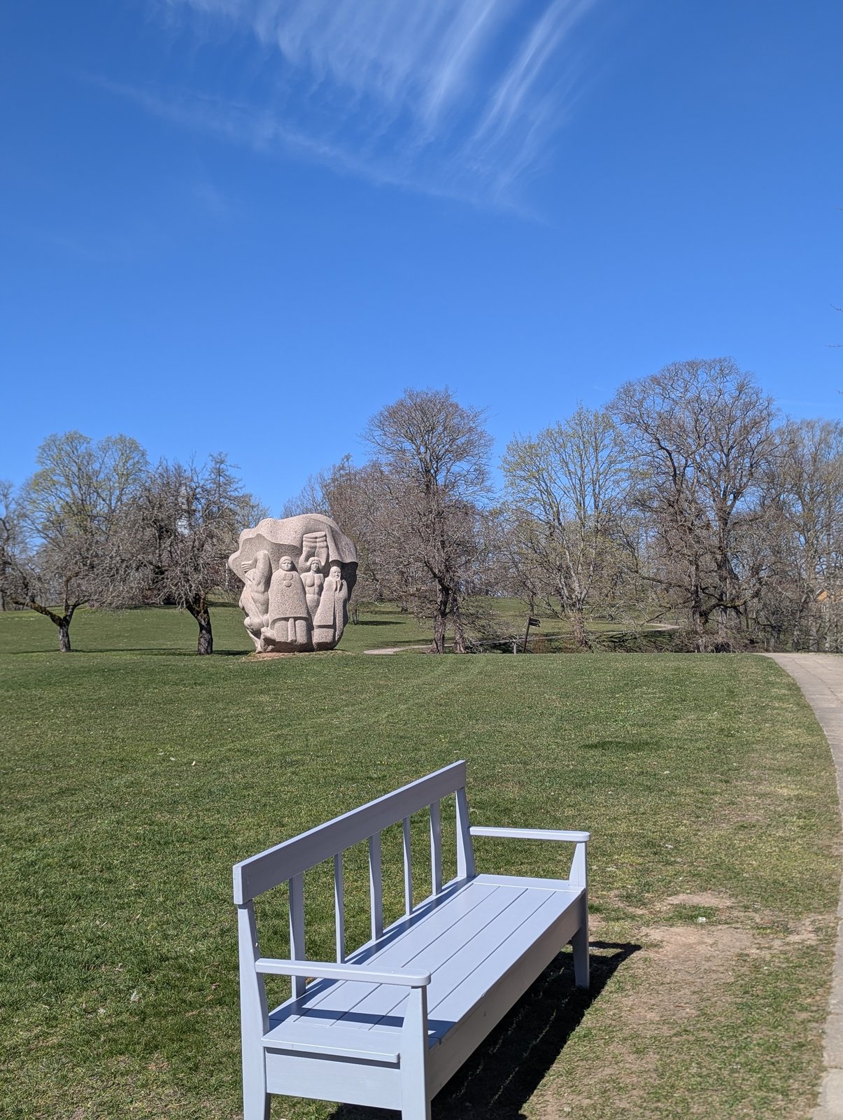 A granite sculpture and bench at Dainu Kalns, the Hill of Dainas at Turaida