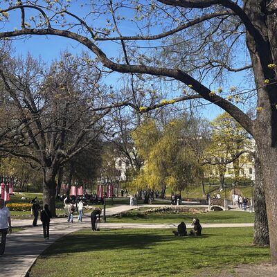 Bastejkalns park on a spring afternoon with people walking, Riga, Latvia