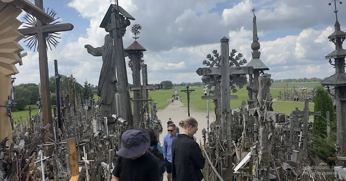Hill of Crosses, Lithuania — boardwalk approach with the pilgrim Jesus statue and hand-carved crosses.