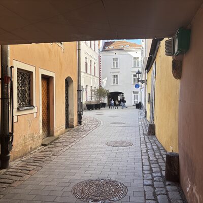 The cobbled inner passage of Konventa Sēta, looking through to the courtyard, Riga, Latvia