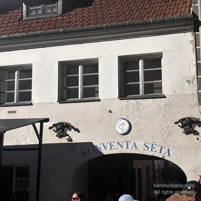 The dove emblem and the dragon-shaped wrought-iron sconces above the Konventa Sēta entrance, Riga, Latvia