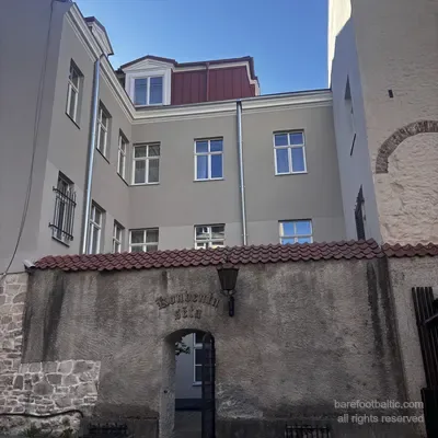 The back gate of Konventa Sēta from Skārņu iela, with the gothic-script sign, Riga, Latvia