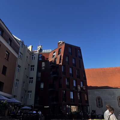The medieval back wall of Konventa Sēta with the modern Redstone Apartments looming over it, Riga, Latvia