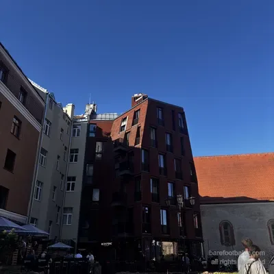 The medieval back wall of Konventa Sēta with the modern Redstone Apartments looming over it, Riga, Latvia