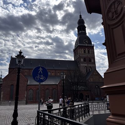 Riga Cathedral on a cloudy spring day with a pedestrian sign in the foreground, Latvia
