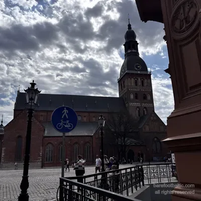 Riga Cathedral on a cloudy spring day with a pedestrian sign in the foreground, Latvia