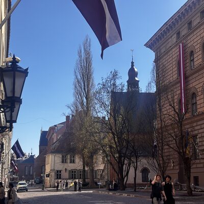 The Saeima (Latvian parliament) with St James's spire above, on Jēkaba iela, Riga, Latvia