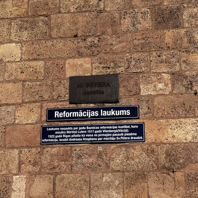 The Reformation Square plaque on the wall of St Peter's Church, Riga, Latvia