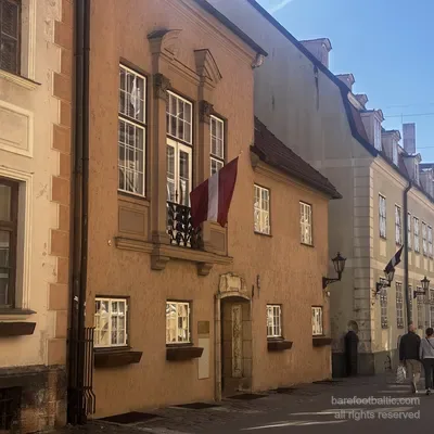 Old houses on Torņa iela with a Latvian flag, near the Swedish Gate, Riga, Latvia