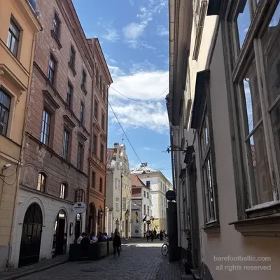 Mazā Pils iela on a spring afternoon with restaurant seating, Riga, Latvia