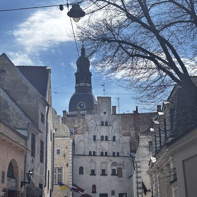 The Three Brothers framed by the cathedral spire, Mazā Pils iela, Riga, Latvia