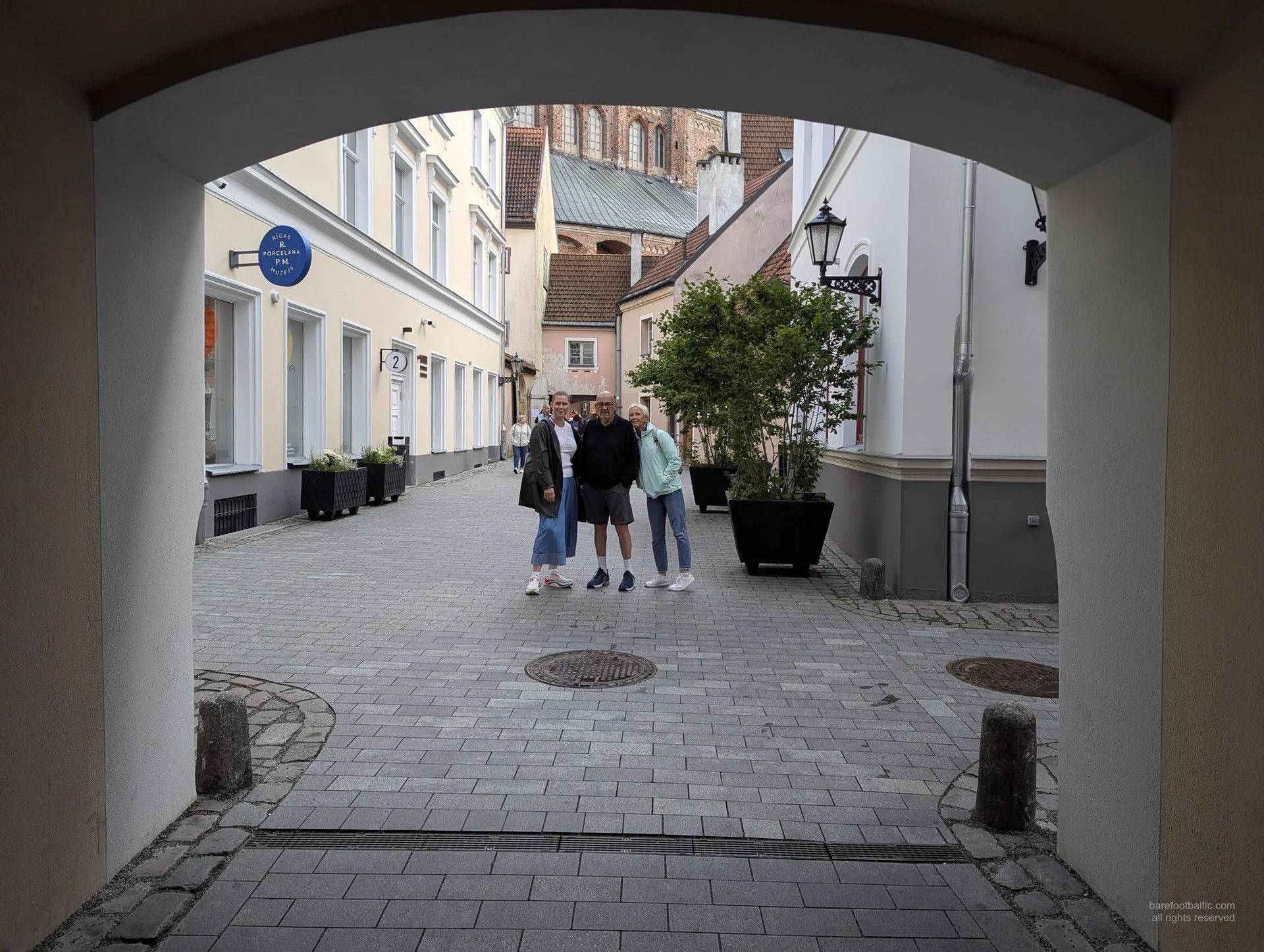 Guests walking through an archway in Riga Old Town