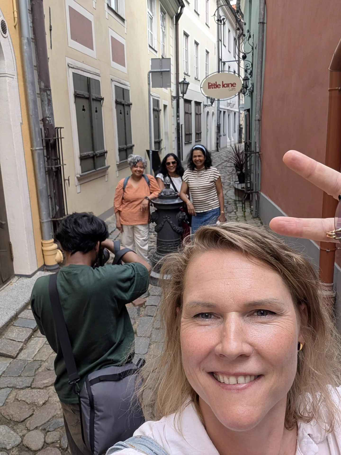 Guide and guests in a Riga Old Town lane