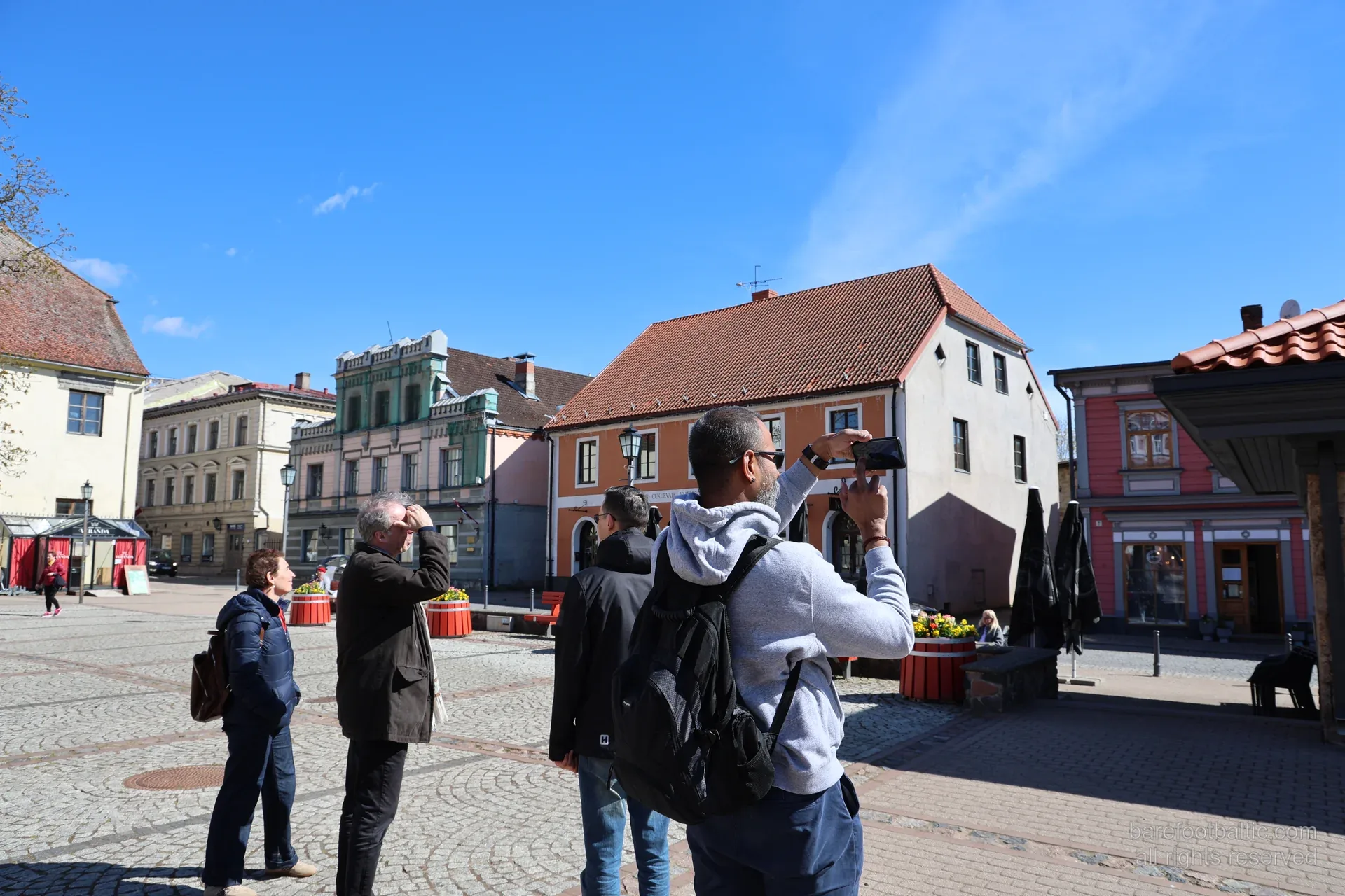 Guests photographing facades in Cesis old town