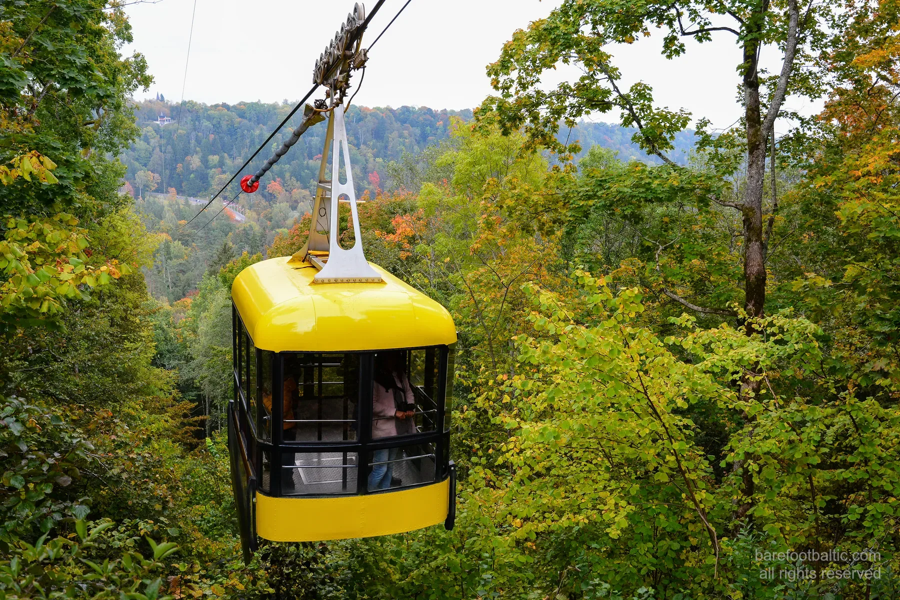 The yellow Soviet-era Sigulda cable car crossing the Gauja valley to Krimulda