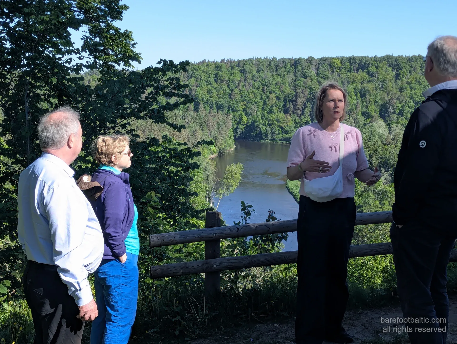 Daiga explaining at a Gauja Valley overlook with guests